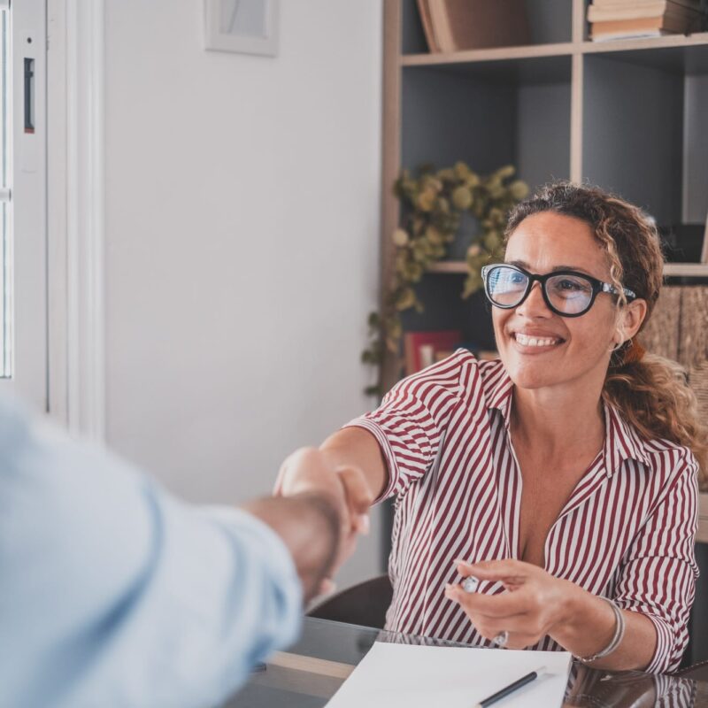 Smiling caucasian female hr manager handshake hire male candidate at job interview Smiling caucasian female hr manager handshake hire male candidate at job interview